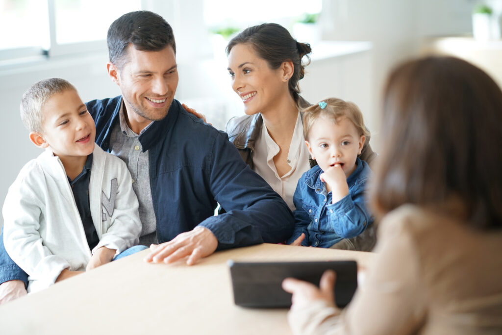 Happy diverse client sitting with accountant going through advisory services to live a financially free life.